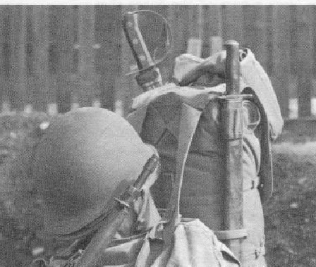 closeup of rucksack showing stored bayonet in front and M1941 Klewang in rear of Ruck Sack