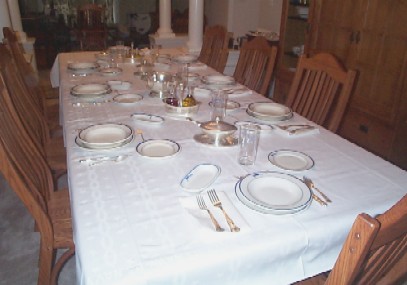 formal dining in ceremony table setting with navy-issued china and silverware